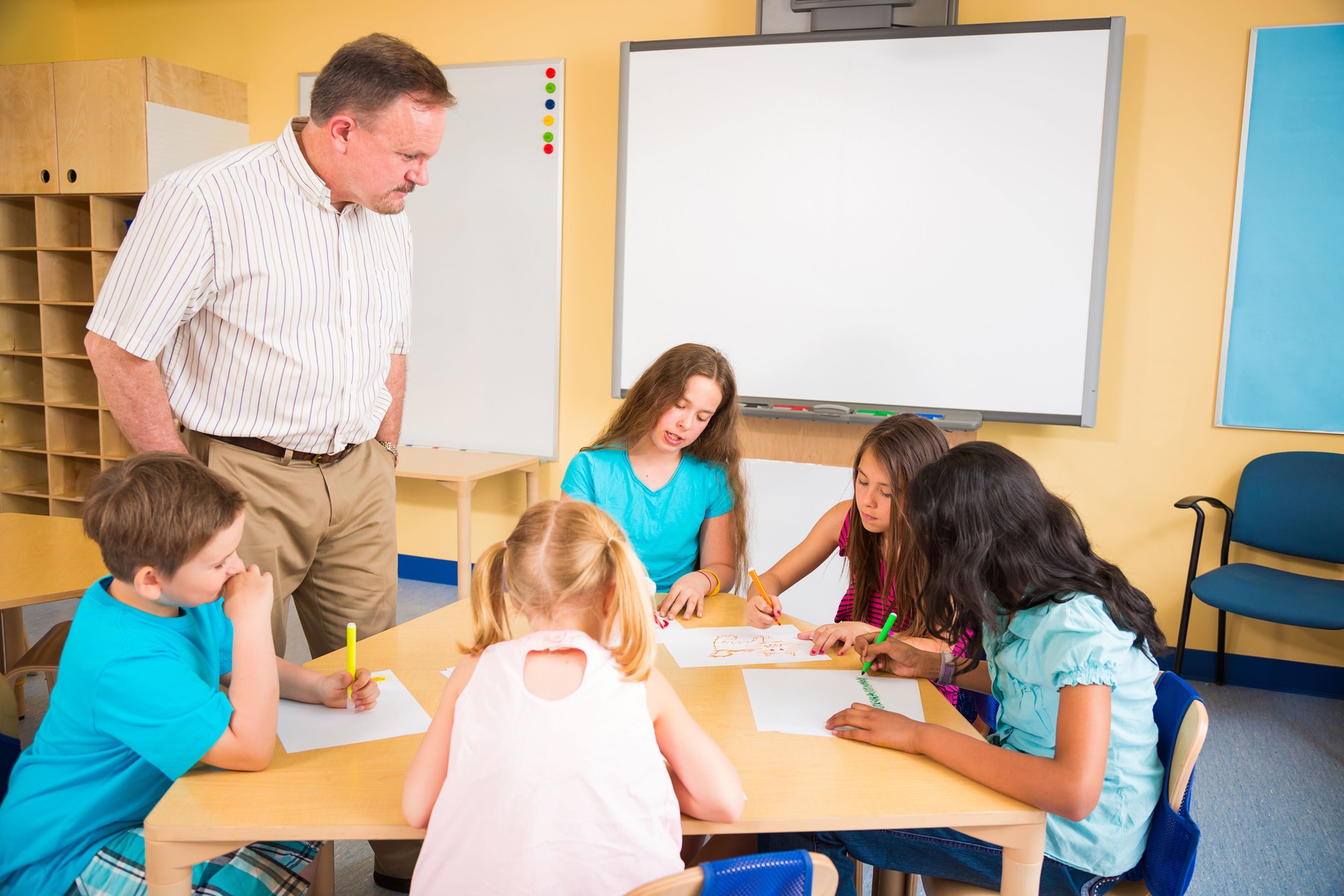 Teacher and school children drawing