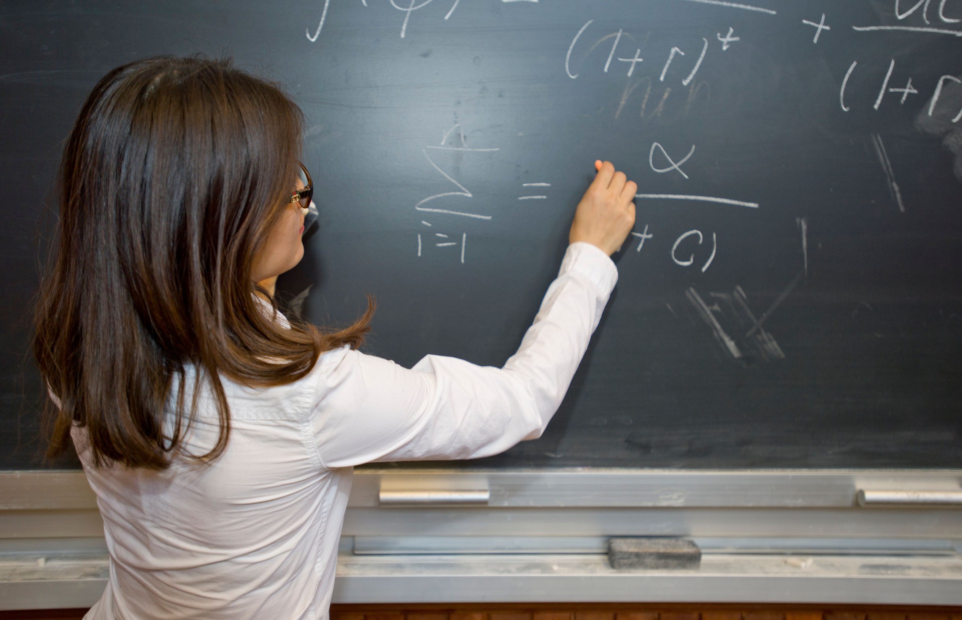woman with chalk on a blackboard